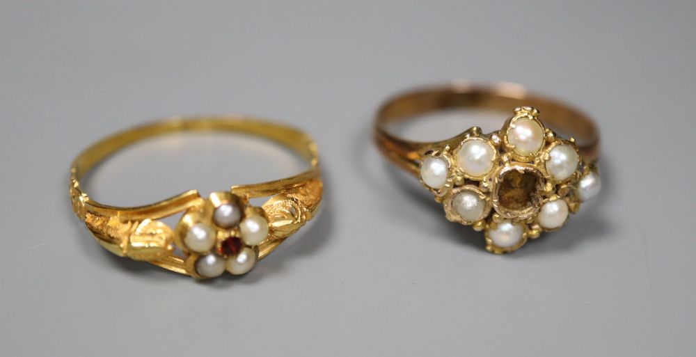 Two late Victorian yellow metal rings- garnet and seed pearl cluster and seed pearl cluster(stone missing), gross 3.4 grams.